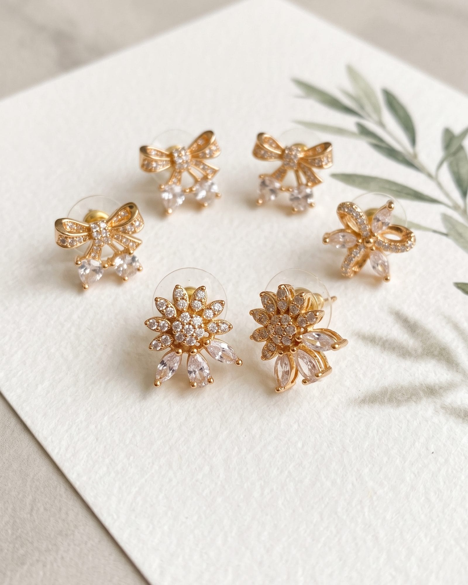 White AD Stone Floral Earrings Set of 3 laid on white marble