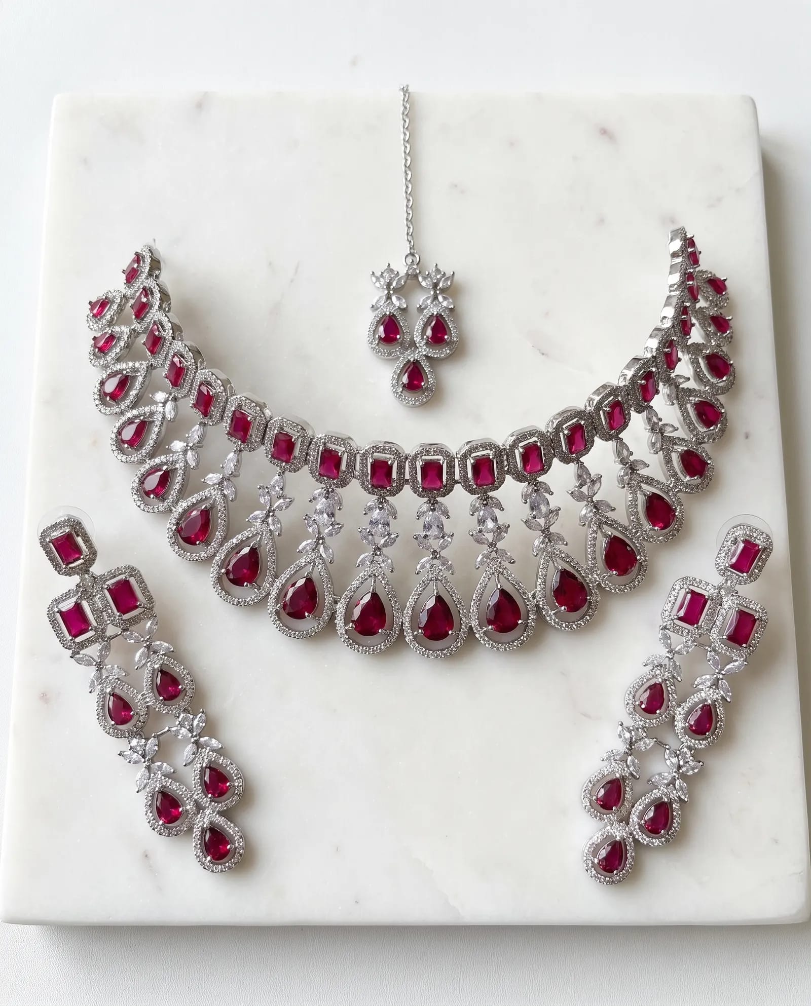 AD stone choker set laid on white marble