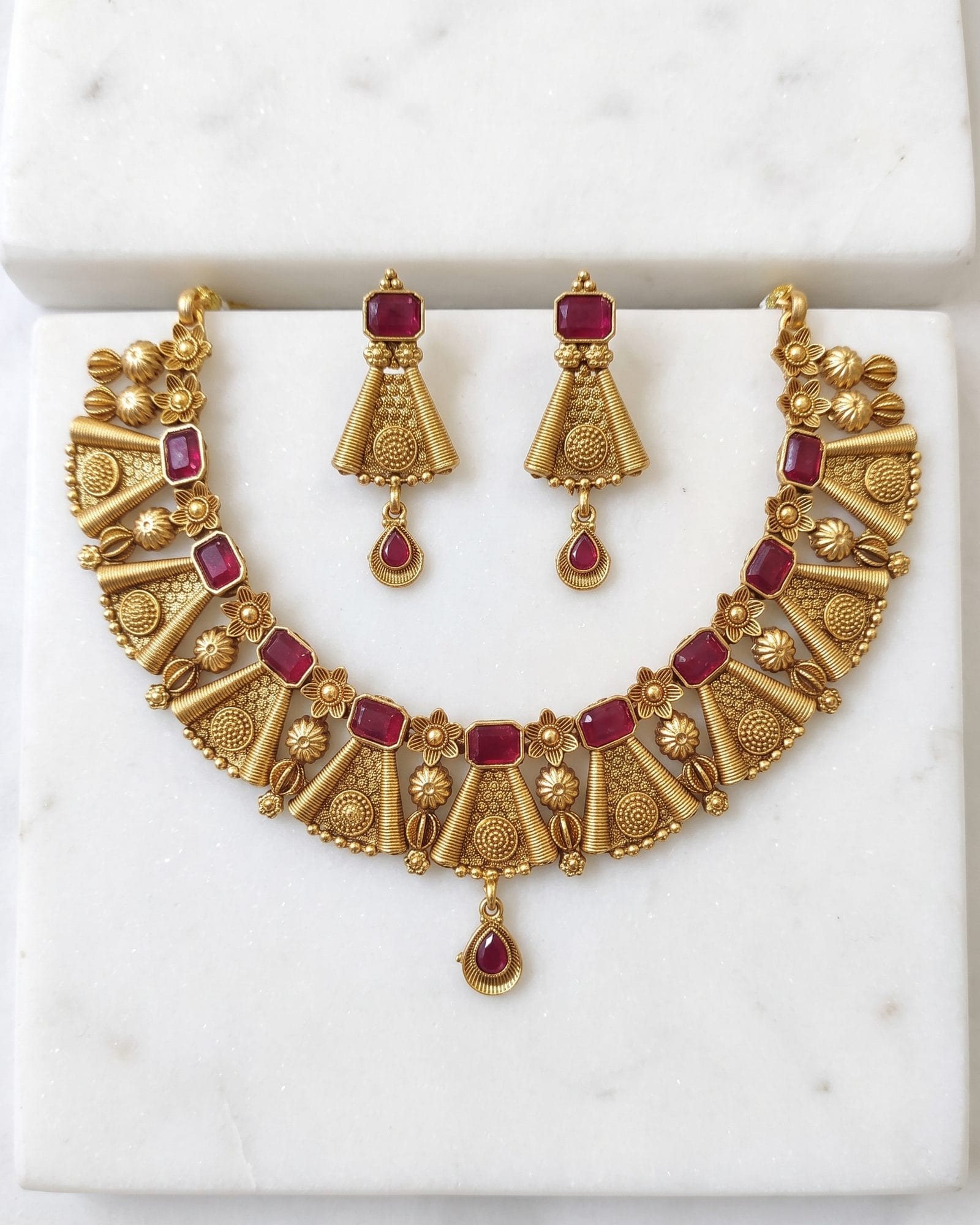 Red Stone Floral Antique Choker Set laid on white marble