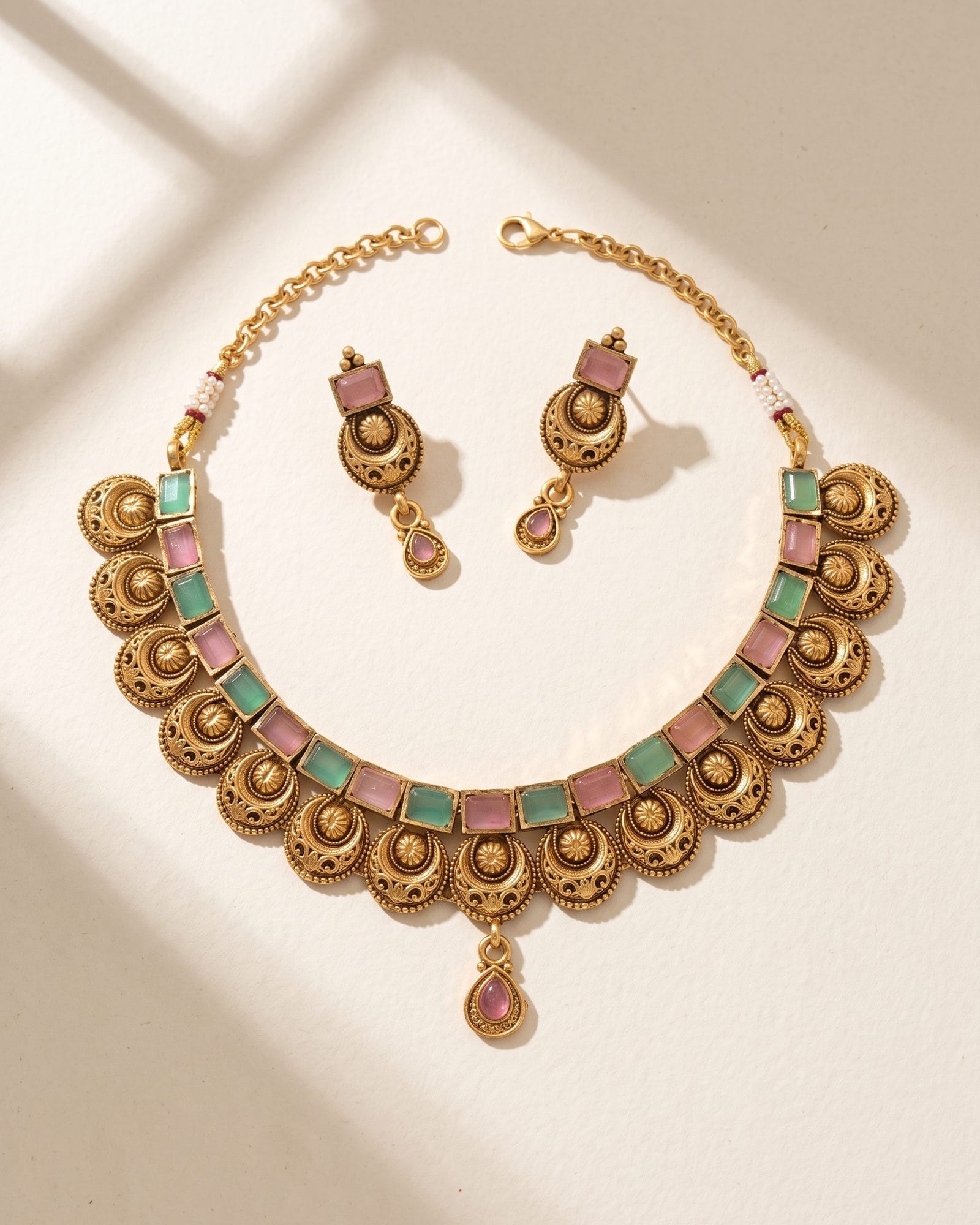 Antique Pink and Green Stone Choker Set laid on white marble