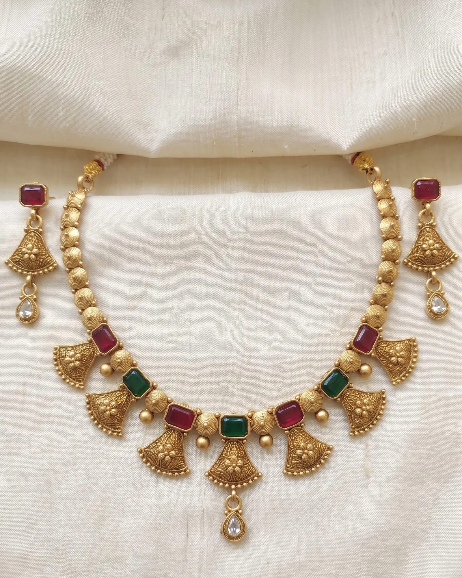 Antique Fan Drop Red Green Stone Choker Set laid on white marble