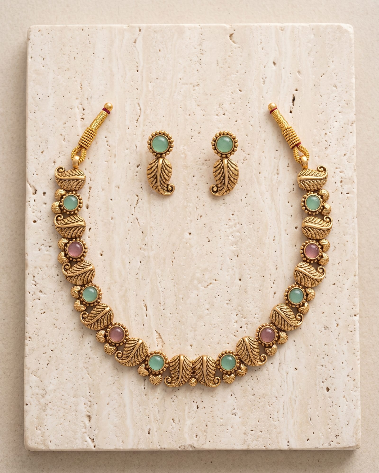 Antique Leaf Motif Stone Choker Set laid on white marble
