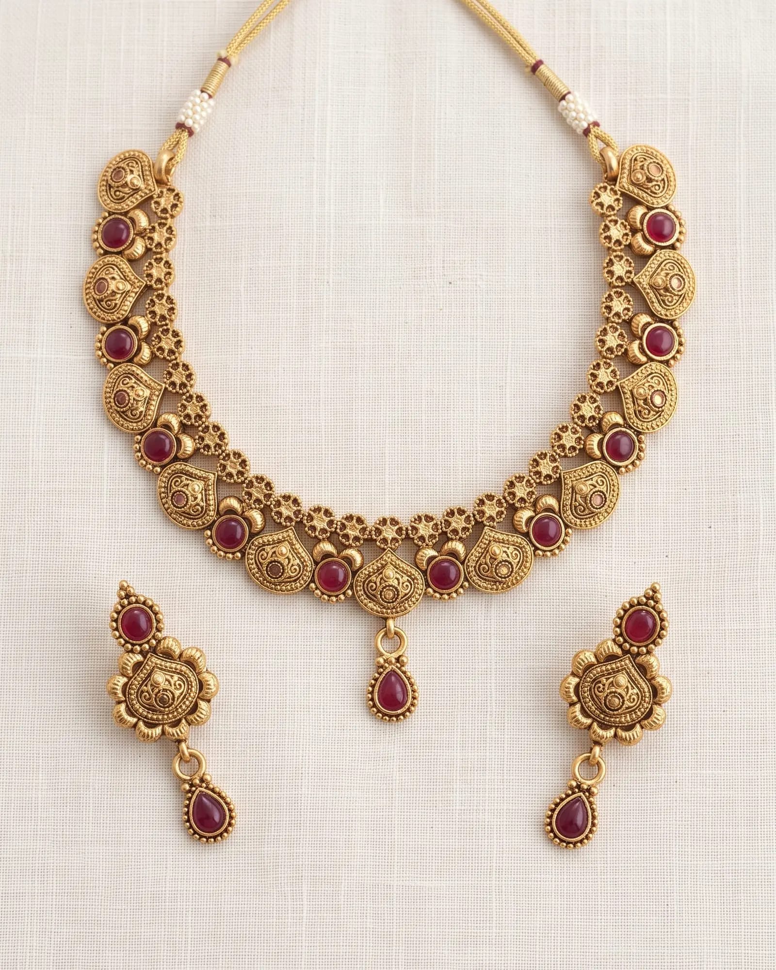 Antique Red Stone Floral Choker Set laid on white marble