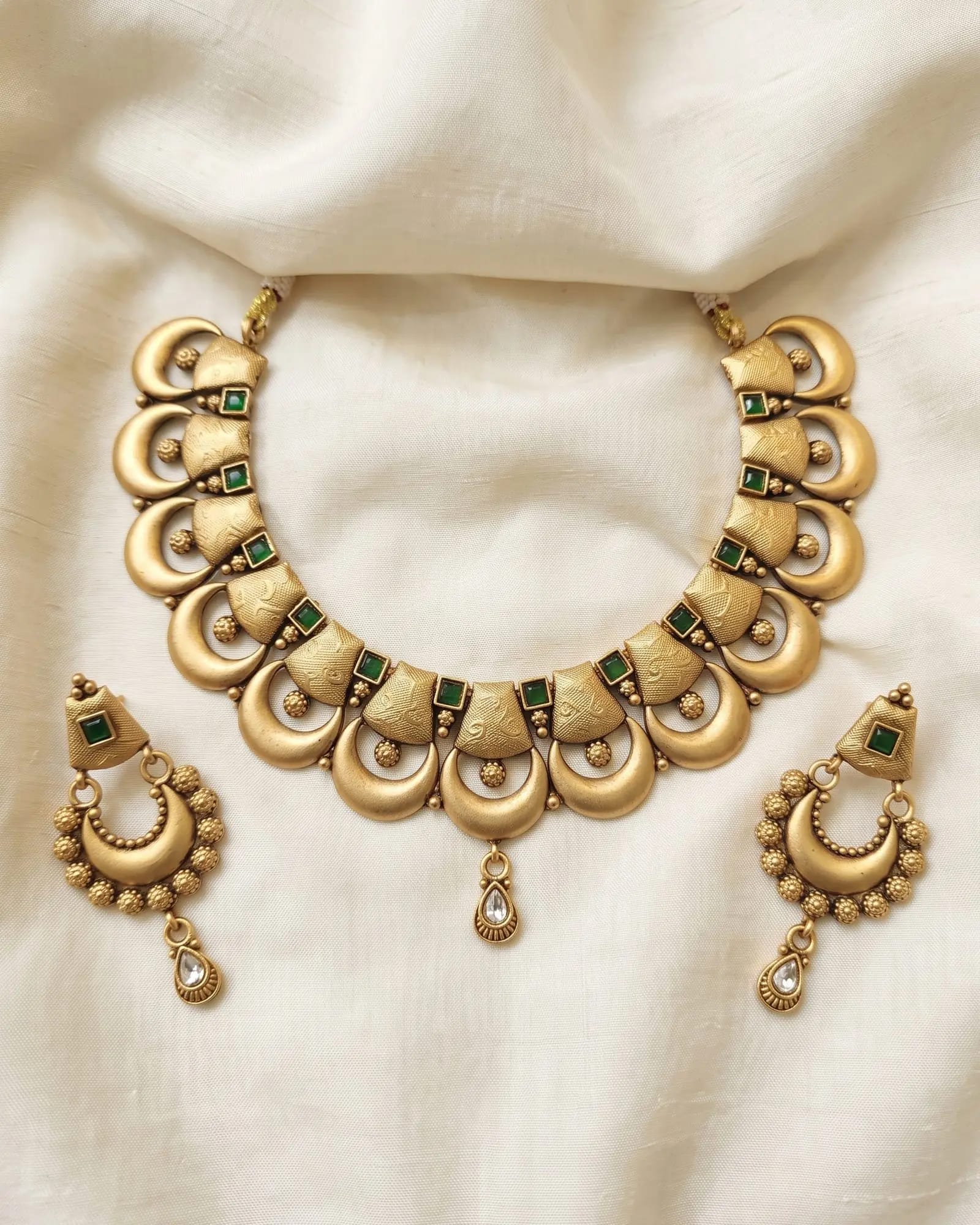 Antique Crescent Green Stone Choker Set laid on white marble