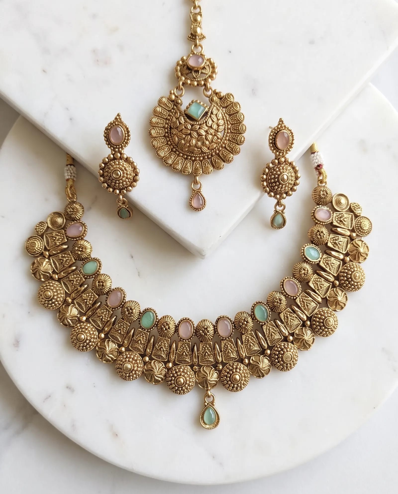 Antique Floral Pink and Green Stone Choker Set laid on white marble