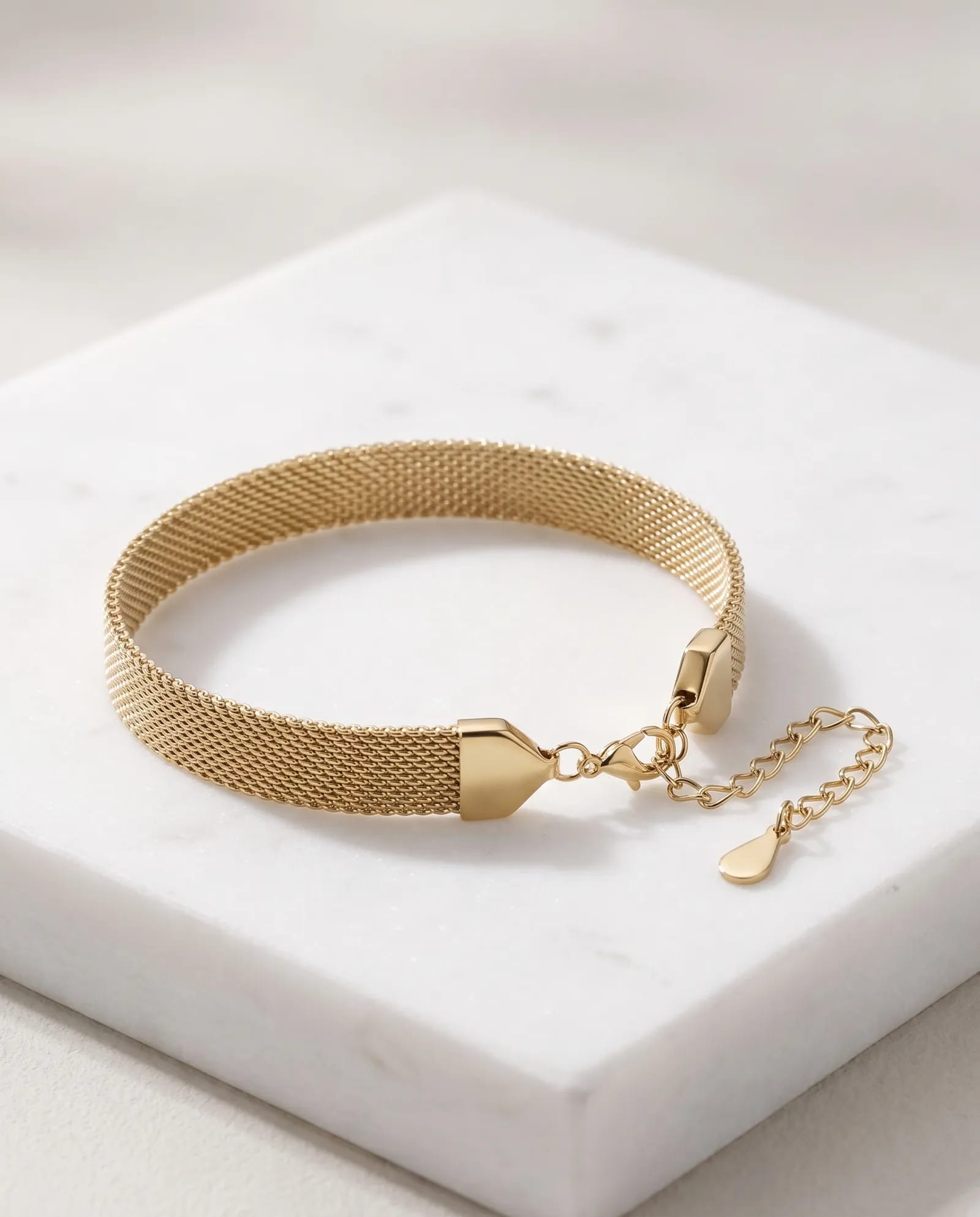 Gold-Tone Stainless Steel Mesh Bracelet laid on white marble