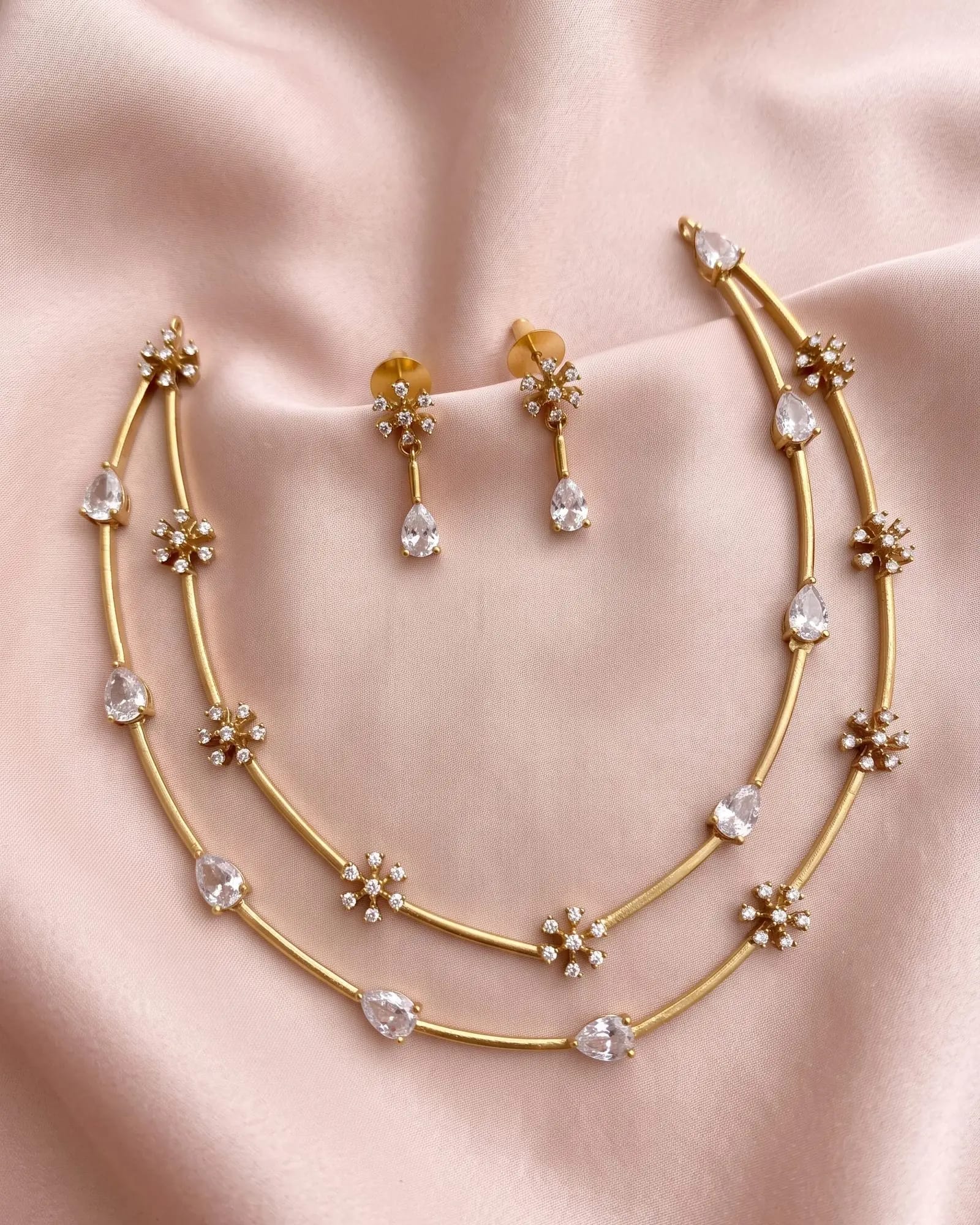 Crystal Bloom Chain Set laid on white marble
