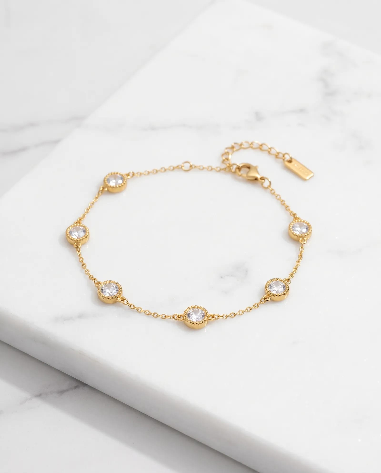 Glimmer Dot Chain Bracelet Anti Tarnish laid on white marble