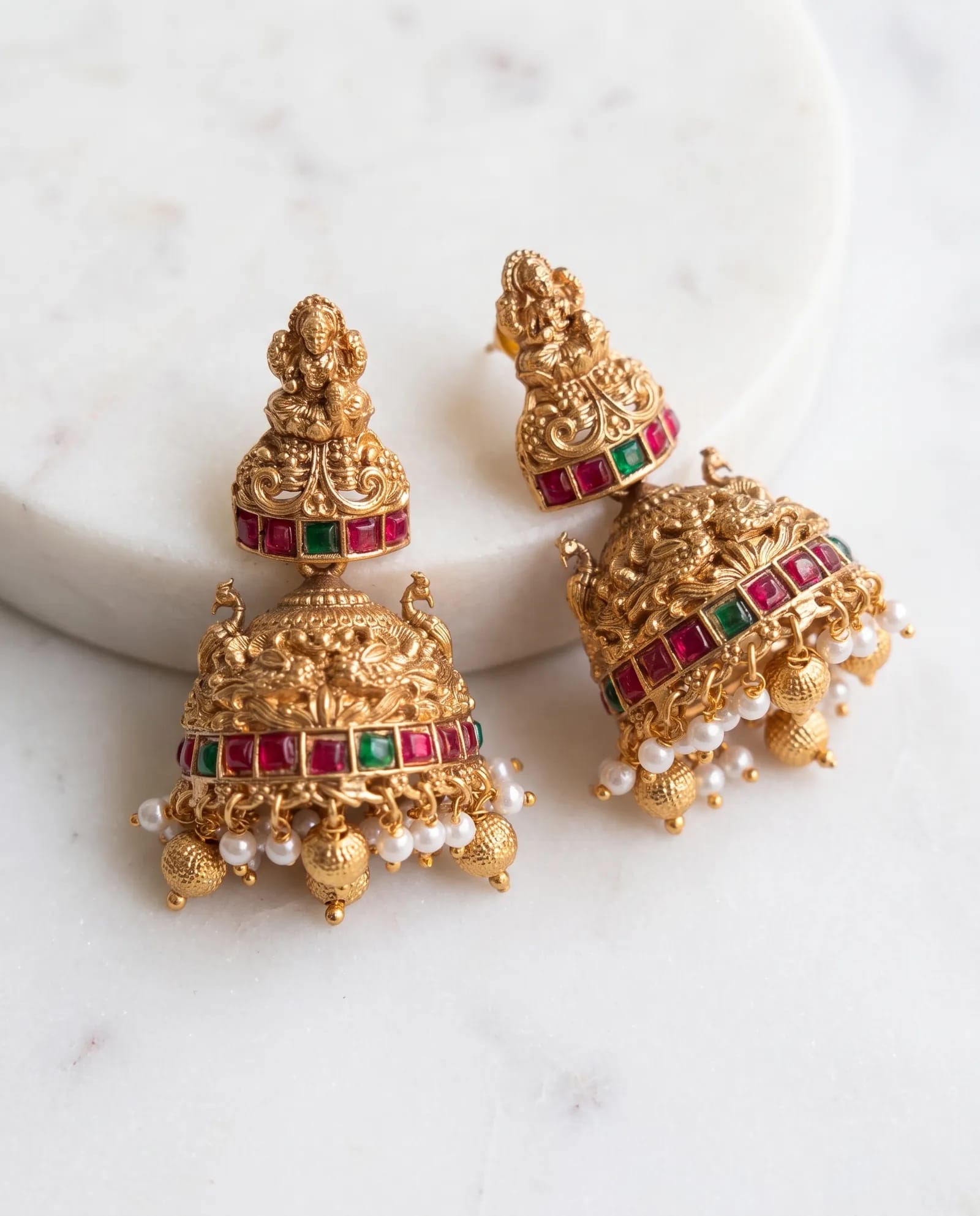 Kemp Jhumkas laid on white marble