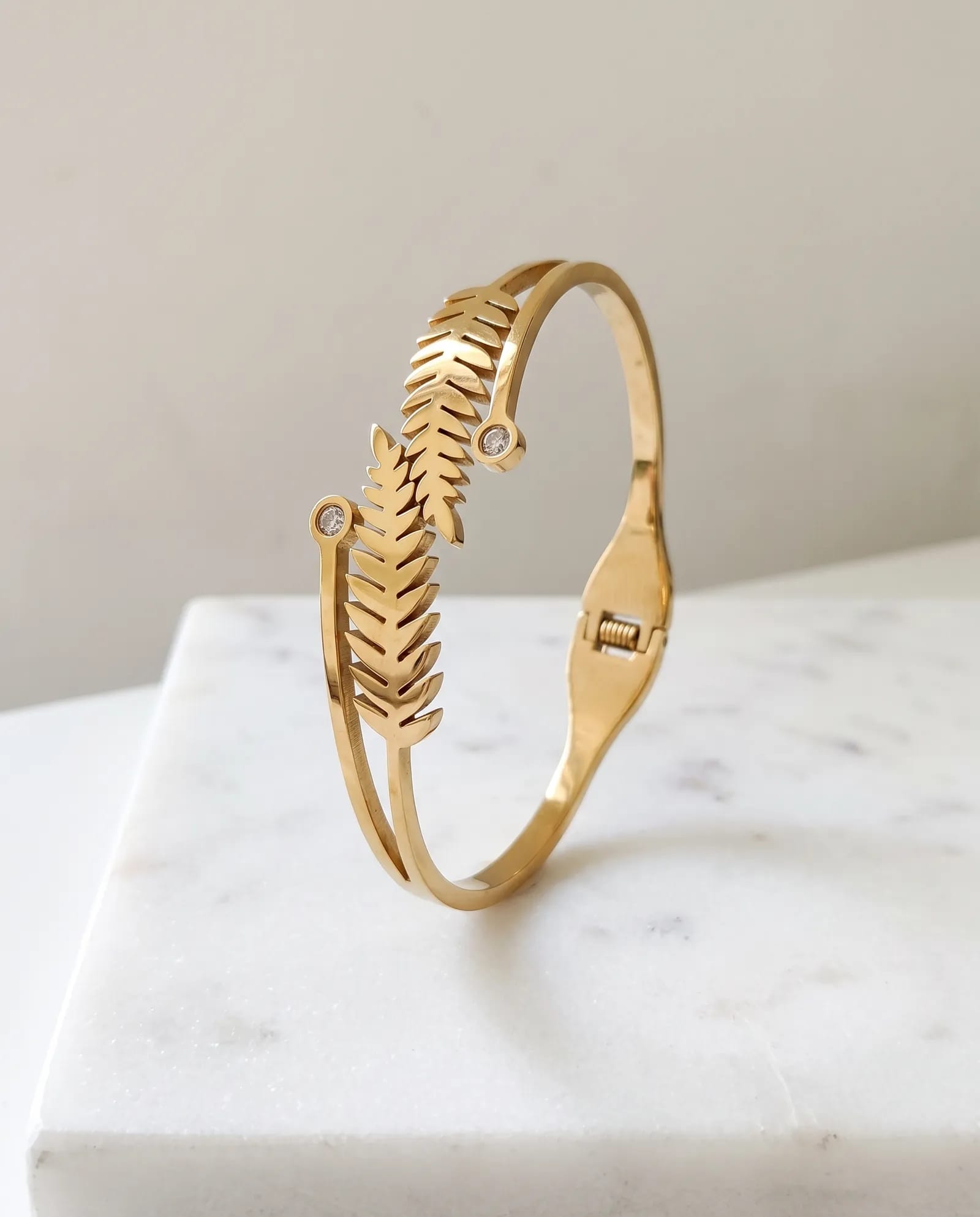 Leaf Bangle Anti Tarnish laid on white marble
