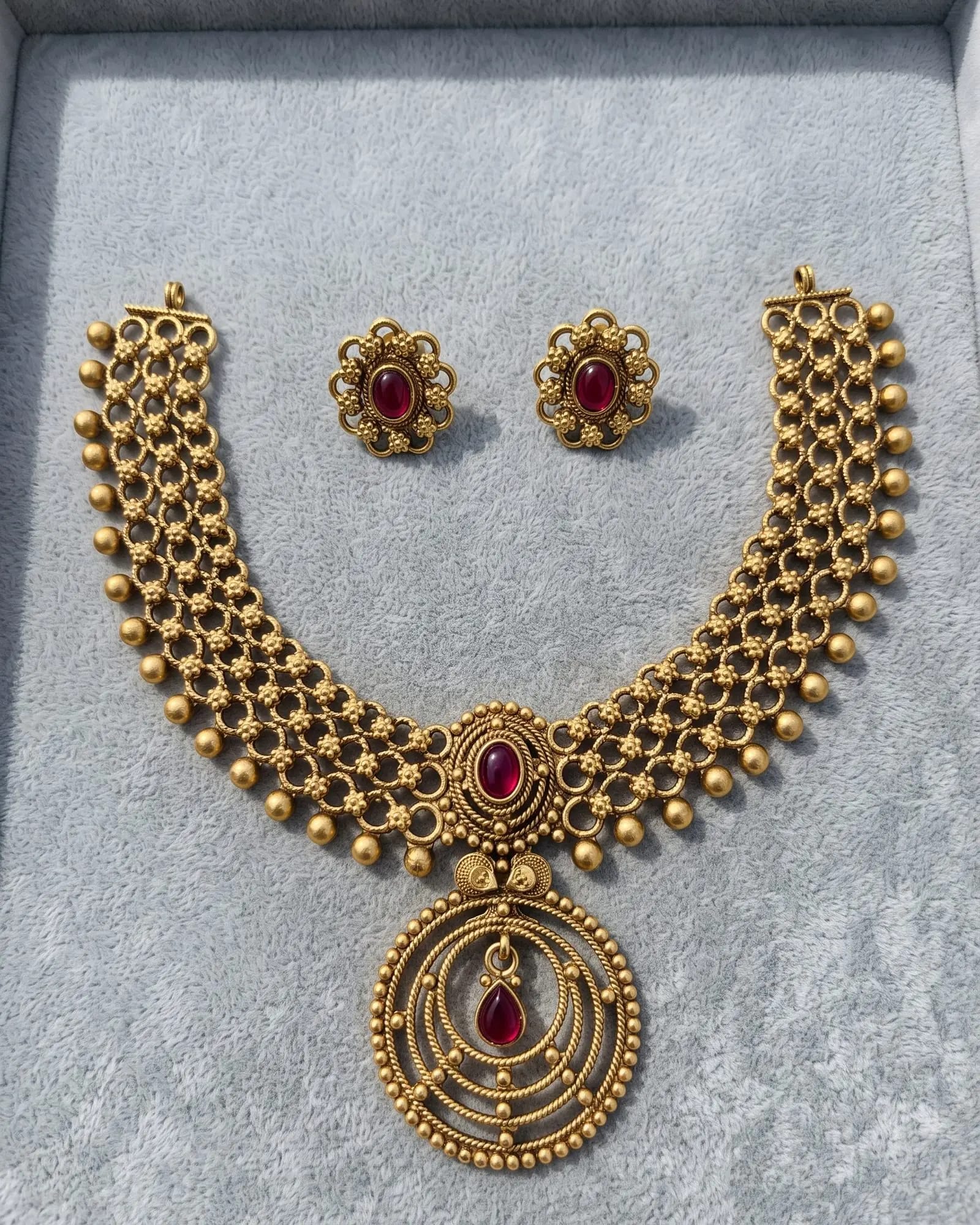 Tamira Necklace set laid on white marble
