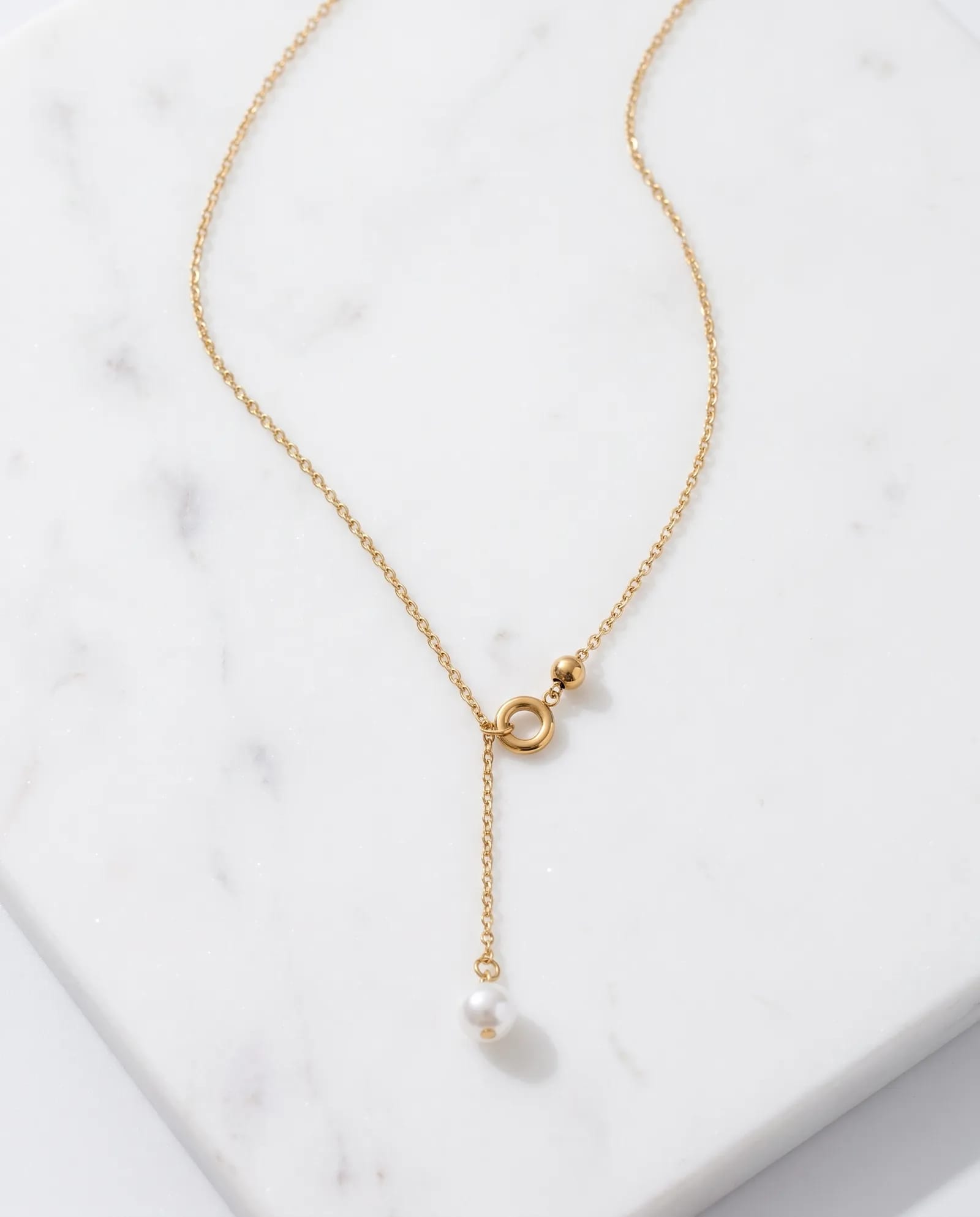 The Pearl Droplet 316L Stainless steel laid on white marble