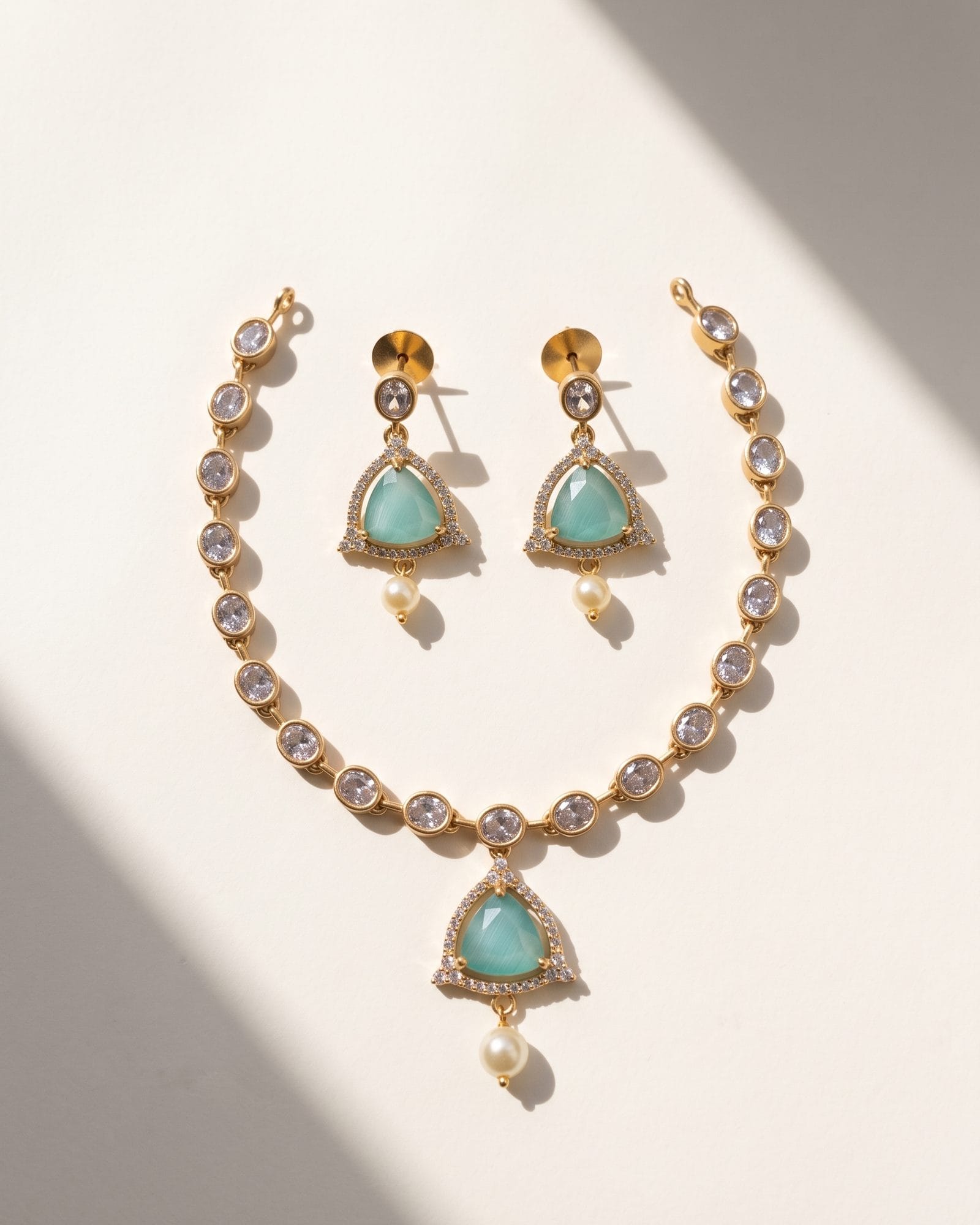 Aqua Glow Necklace Set laid on white marble