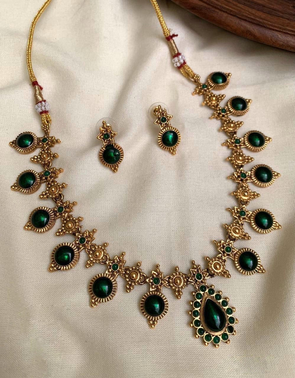 	Antique gold temple necklace set with green stones and earrings