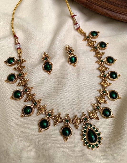 	Antique gold temple necklace set with green stones and earrings